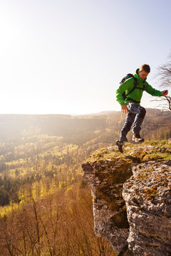 Albstatt-Onstmettingen, Baden-W&cedil;rttemberg, Germany: A male hiker on the "Hangender Stein" cliff along the "Traufgang Zollernburg-Panorama" trail.