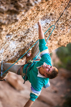 A male climber on Sativa patatica (8a) at the Raco de les Tenebres sector at Margalef, Spain.