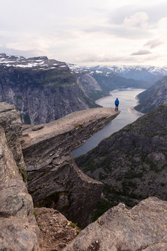 Rear view of man standing on mountain edge