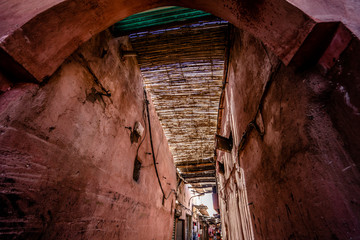 Colorful ancient old and narrow street in medina of Marrakech, Morocco, Africa