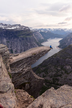Trolltunga hike, Odda, Hordaland, Norway: A hiker on the Trolltunga rock before sunset.