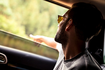 Williams, Arizona, USA: A male passenger with his hand out the window to feel the fresh air.