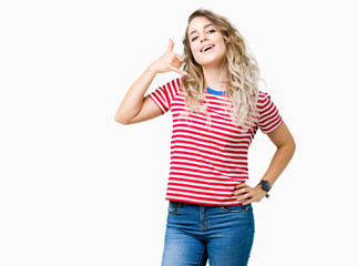 Beautiful young blonde woman over isolated background smiling doing phone gesture with hand and fingers like talking on the telephone. Communicating concepts.