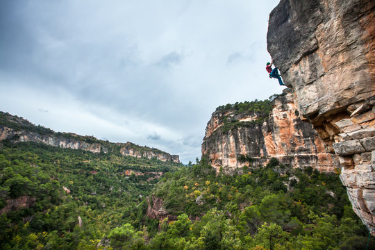 A man on the seemingly-sandbagged, slightly-loose, little-climbed-but-extremely-aesthetic Baby Boom (7a) in Siurana, Catalonia in Spain.