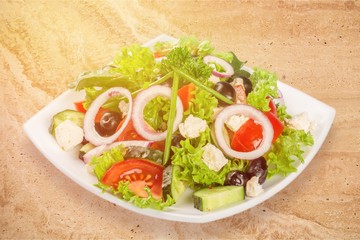 Fresh tasty vegetable salad in bowl on white background
