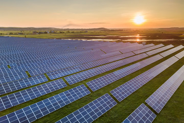 Blue solar photo voltaic panels system producing renewable clean energy on rural landscape and...