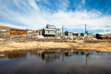 The old mill reflects off of a pond at the Bodie gold mining ghost town in California.