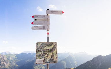 Walmendingerhorn, Kleinwalsertal, Austria: A guidepost close to the top of the Walmendingerhorn with the Alps in the background.