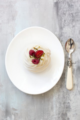 Pavlova cakes with cream and fresh summer berries