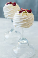Pavlova cakes with cream and fresh summer berries