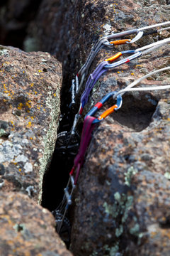 A three point climbing anchor using three camming devices as protection at Trout Creek, a climbing area in central Oregon.      