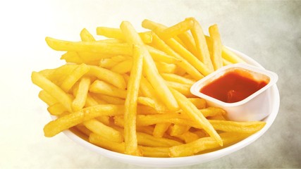 Fresh fried french fries with ketchup on wooden background