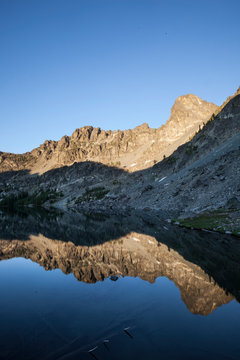 Sheep Lake in the Seven Devil Mountains in Central Idaho at sunset. A peak named Tower of Babel sits in the background.    