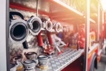 Fire hoses in red fighting machine are dug out and ready for use