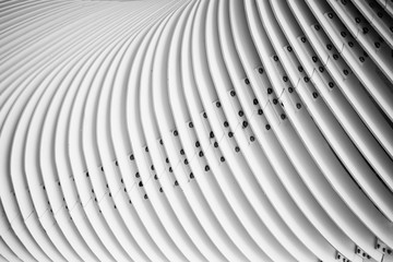 Abstract details of curved metal stairs. Black and white photography.