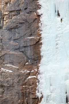 A man on the third pitch of Hydrophobia (WI5+) a 500 foot ice climb in the Ghost River Wilderness Area in Alberta, Canada.