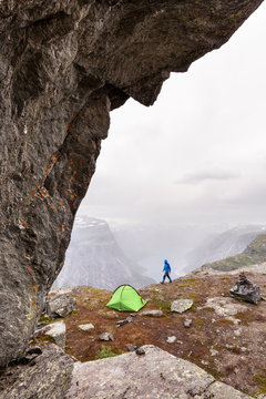 Trolltunga hike, Odda, Hordaland, Norway: The camp of a single backpacker just off of Trolltunga with a stunning view over the fjord and mountains.