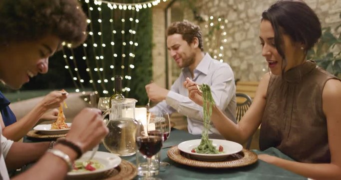 Four People, Two Couples Happy Talking And Eating During A Romantic Gourmet Dinner Or Lunch.Wide Shot. Friends Italian Trip In Umbria.4k Slow Motion