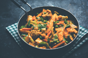 Mix vegetable curry - Indian main course recipe contains Carrots, cauliflower, green peas and beans, baby corn, capsicum and paneer/cottage cheese with traditional masala and curry, selective focus