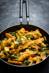 Mix vegetable curry - Indian main course recipe contains Carrots, cauliflower, green peas and beans, baby corn, capsicum and paneer/cottage cheese with traditional masala and curry, selective focus
