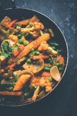 Mix vegetable curry - Indian main course recipe contains Carrots, cauliflower, green peas and beans, baby corn, capsicum and paneer/cottage cheese with traditional masala and curry, selective focus