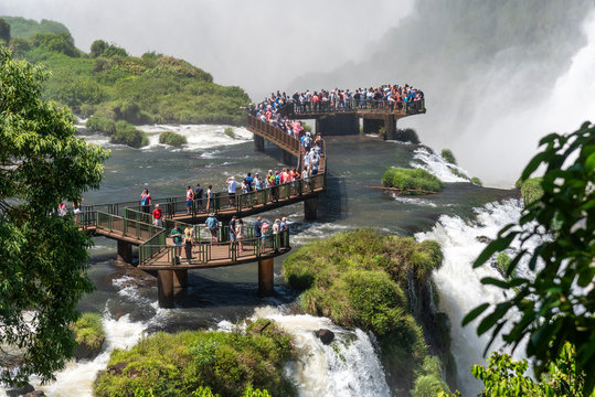 Beautiful landscape of tourists on footbridge visiting big waterfalls