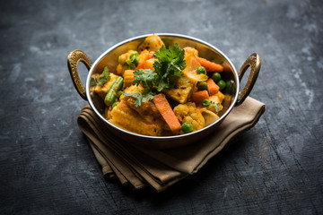 Mix vegetable curry - Indian main course recipe contains Carrots, cauliflower, green peas and beans, baby corn, capsicum and paneer/cottage cheese with traditional masala and curry, selective focus