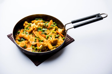 Mix vegetable curry - Indian main course recipe contains Carrots, cauliflower, green peas and beans, baby corn, capsicum and paneer/cottage cheese with traditional masala and curry, selective focus
