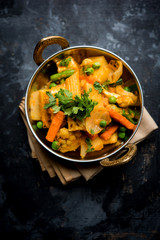 Mix vegetable curry - Indian main course recipe contains Carrots, cauliflower, green peas and beans, baby corn, capsicum and paneer/cottage cheese with traditional masala and curry, selective focus