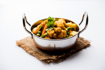 Mix vegetable curry - Indian main course recipe contains Carrots, cauliflower, green peas and beans, baby corn, capsicum and paneer/cottage cheese with traditional masala and curry, selective focus
