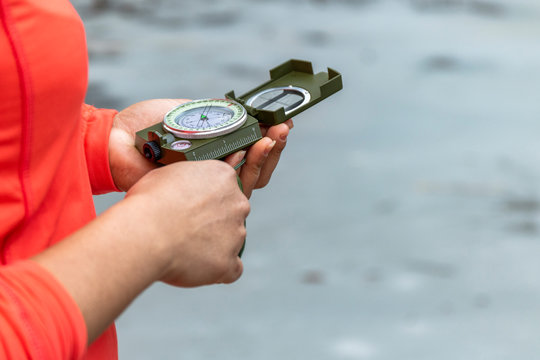 Hands Of A Woman In The Outdoors Using A Compass To Navigate