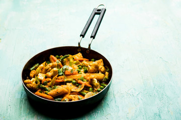 Mix vegetable curry - Indian main course recipe contains Carrots, cauliflower, green peas and beans, baby corn, capsicum and paneer/cottage cheese with traditional masala and curry, selective focus