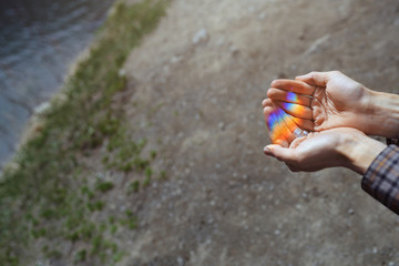 Human hands catching the rainbow light made by prism