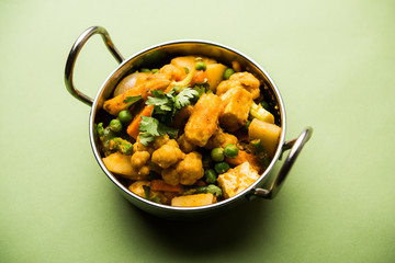 Mix vegetable curry - Indian main course recipe contains Carrots, cauliflower, green peas and beans, baby corn, capsicum and paneer/cottage cheese with traditional masala and curry, selective focus