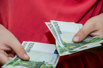 business woman holding 100 euro in her hands, close-up