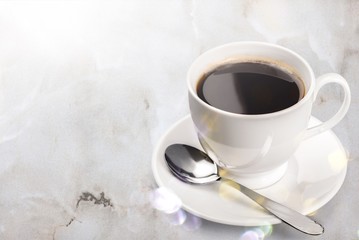 Coffee cup and spoon on wooden background