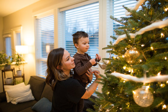 Mother and son decorate the family Christmas Tree
