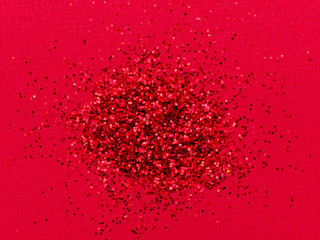 Red glitter sparkle on red background with place for your text