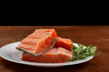 fillet of red trout fish on a plate. trout on wooden background
