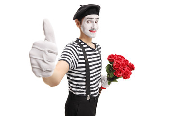 Mime holding a bunch of red roses showing thumbs up