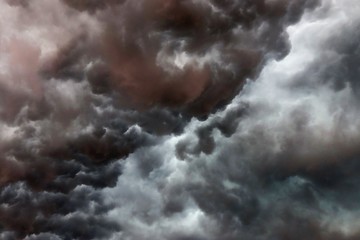Very dark cloud formations of a heavy thunderstorm during sunset