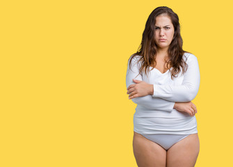 Beautiful plus size young overwight woman wearing white underwear over isolated background skeptic...
