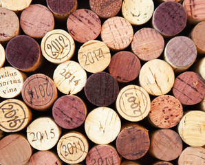 Wine corks with different years and red colored stains, close-up