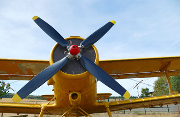 Old biplane close-up. Front view, with the side of the fuselage.