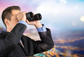 Young handsome man in shirt  with binoculars