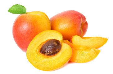 apricot fruits with slices and green leaf isolated on white background