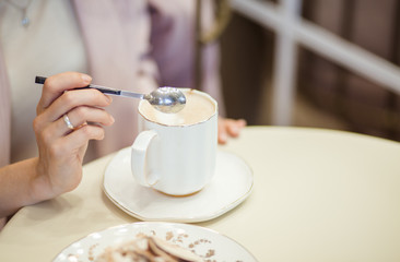 Morning coffee. Woman holds a disposable coffee cup