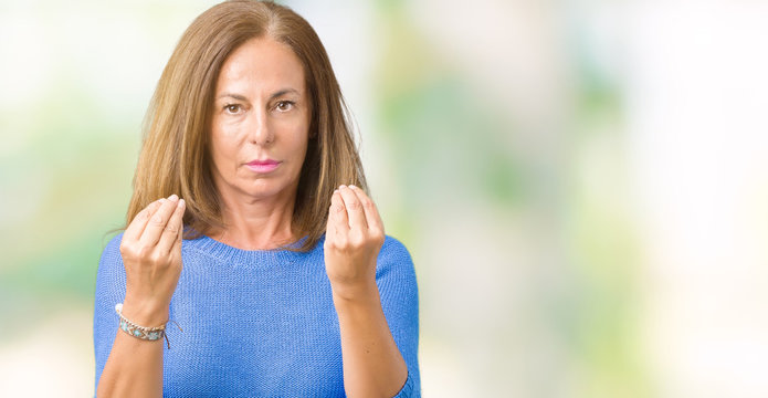 Middle age beautiful woman wearing winter sweater over isolated background Doing money gesture with hand, asking for salary payment, millionaire business