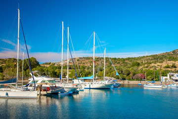 Fototapeta na wymiar View of the Gumusluk, Bodrum Marina, sailing boats and yachts in Bodrum town, city of Turkey. Shore and coast of Aegean Sea with yachts and boats