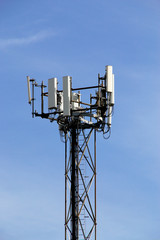 Hightech telecommunication broadcast tower on sky background. Cellular signal tower.